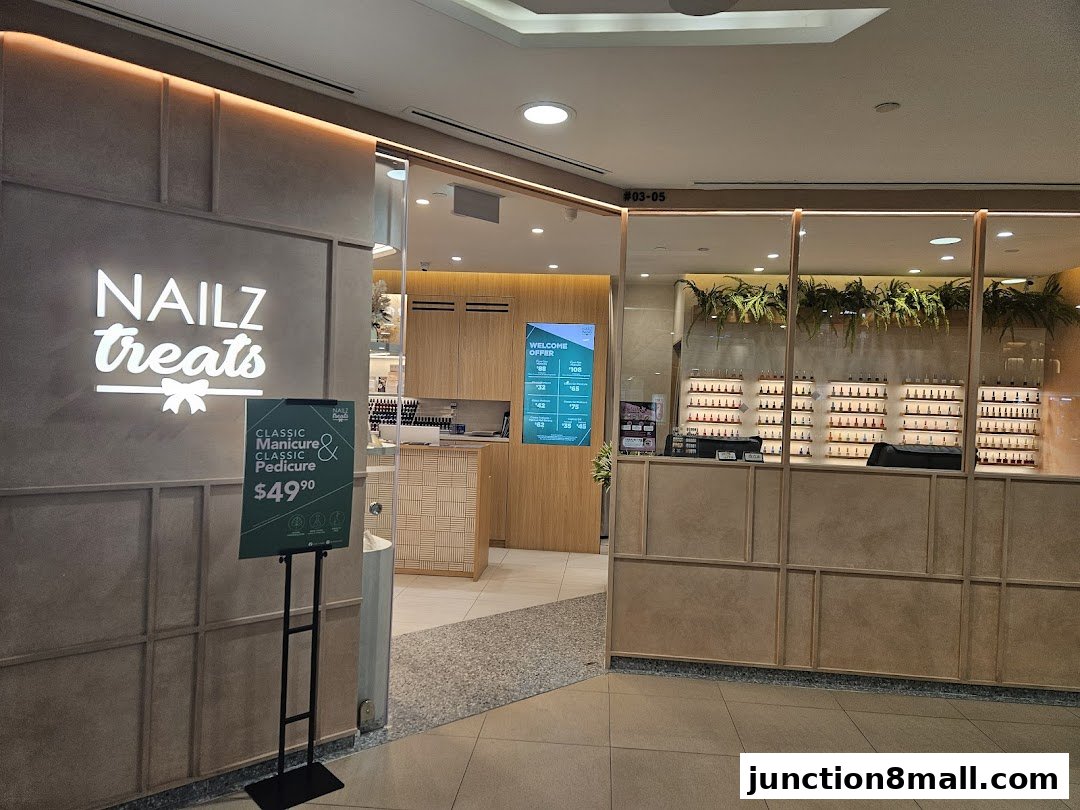 The entrance to Nailz Treats, a nail salon, with its logo and a promotional sign.