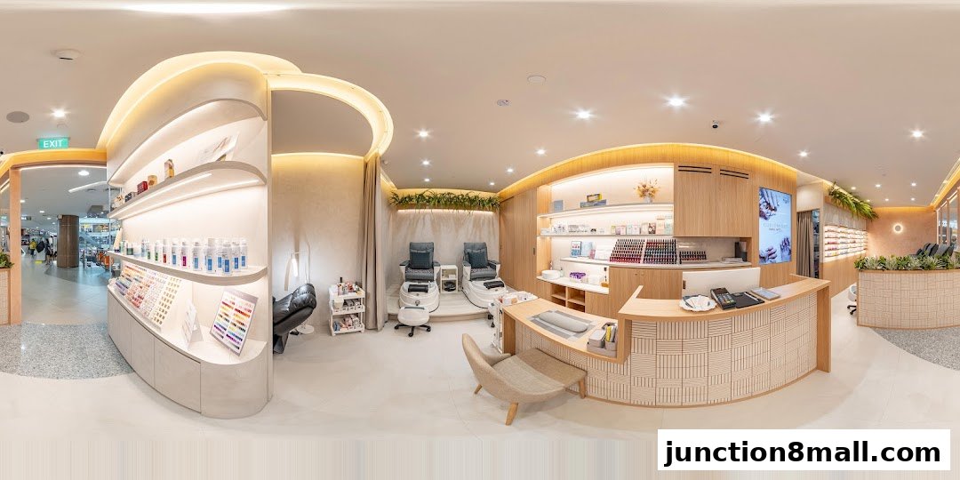 Interior view of a modern nail salon with pedicure chairs, nail polish displays, and a reception desk.