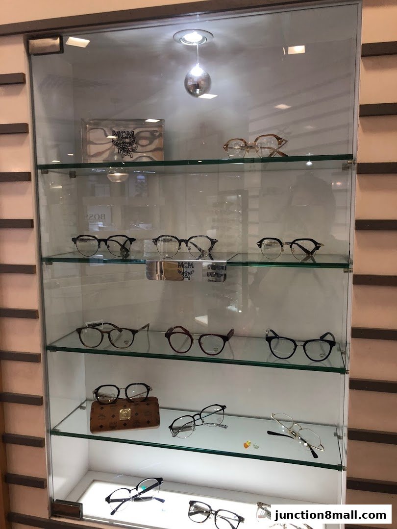 A display cabinet showcasing a variety of eyeglasses and a branded glasses case.
