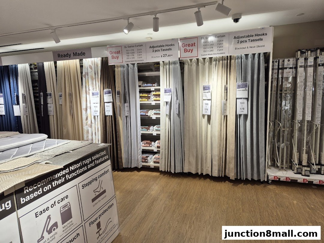 Interior view of a Nitori store showcasing various curtains and curtain accessories.