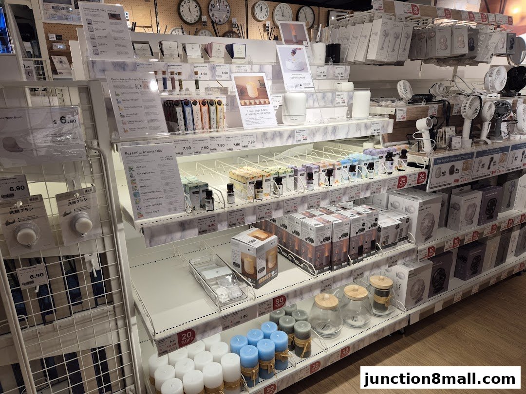 Shelves stocked with aroma oils, fans, and candles, with price tags visible.