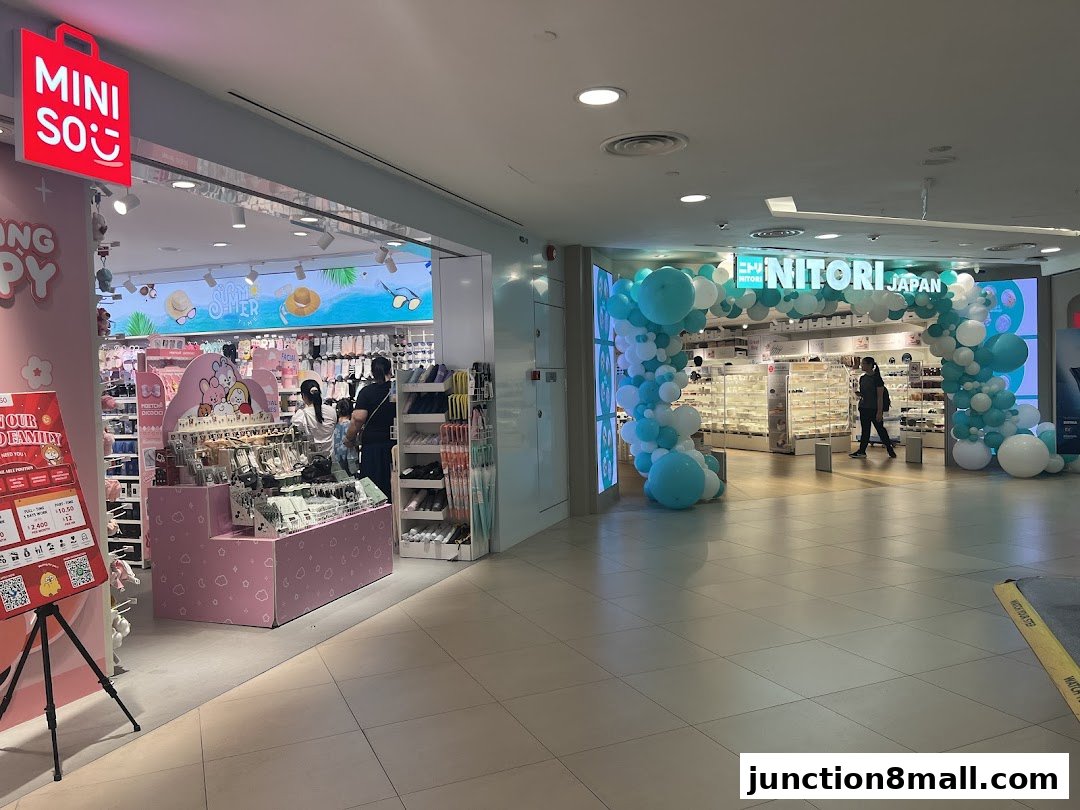 Two shops, MINISO and NITORI JAPAN, are visible in a mall, decorated with balloons.