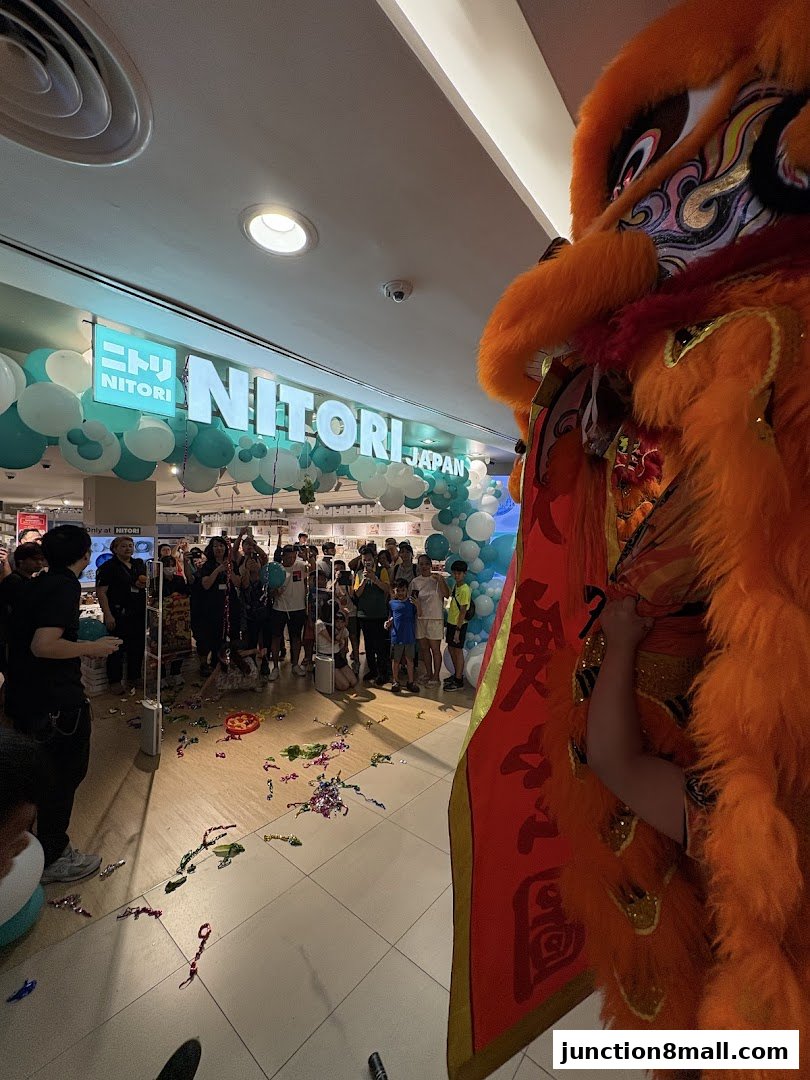 NITORI JAPAN store opening with a lion dance performance and balloons.