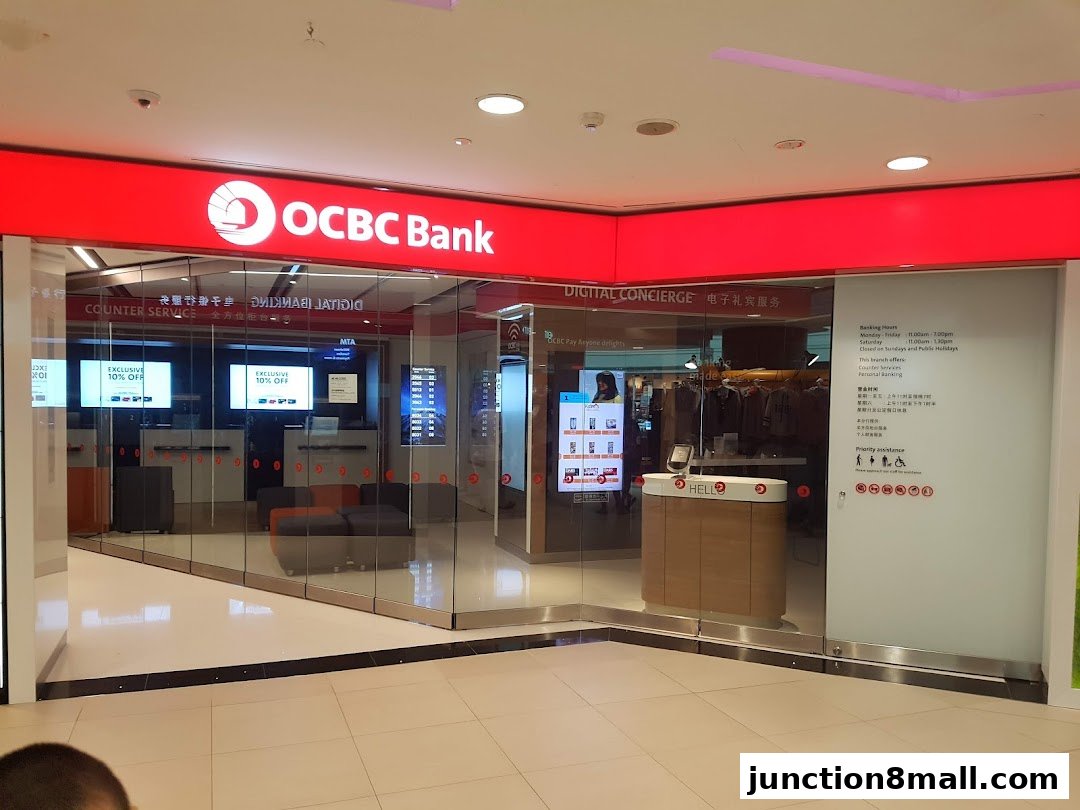 The OCBC Bank branch entrance with digital displays and banking services information.