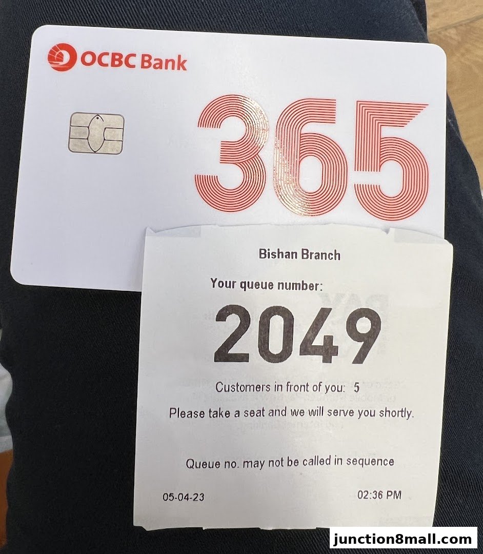A queue ticket from OCBC Bank Bishan Branch with queue number 2049.