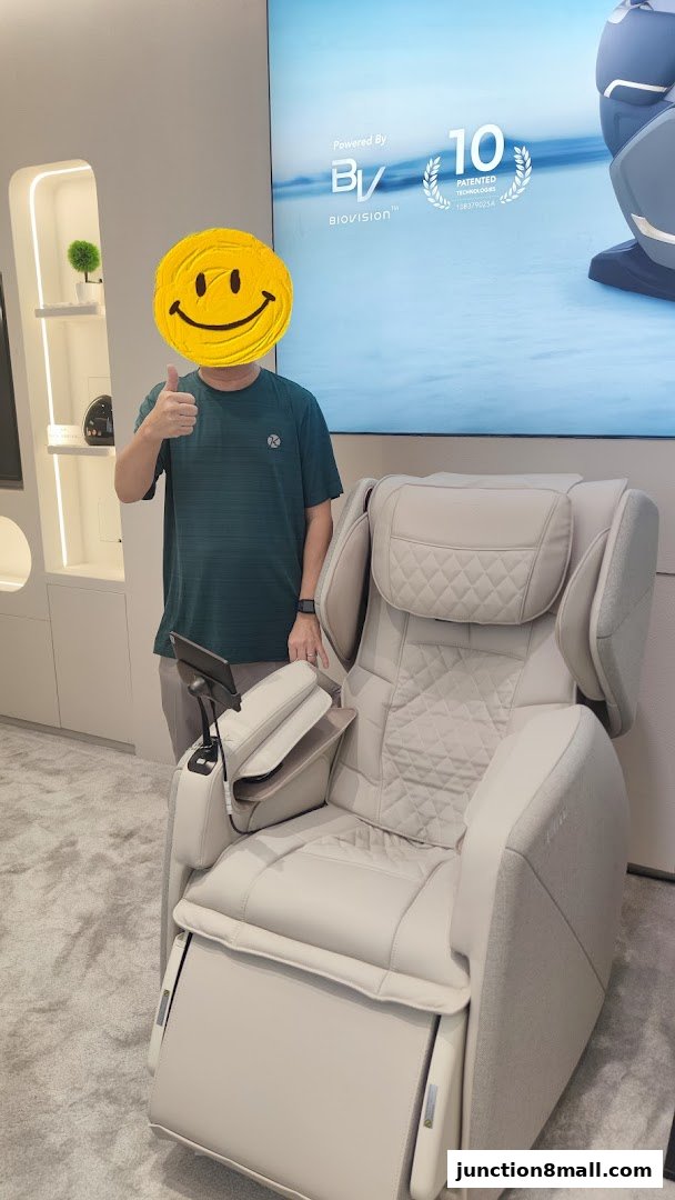 A person gives a thumbs up next to a luxurious massage chair.