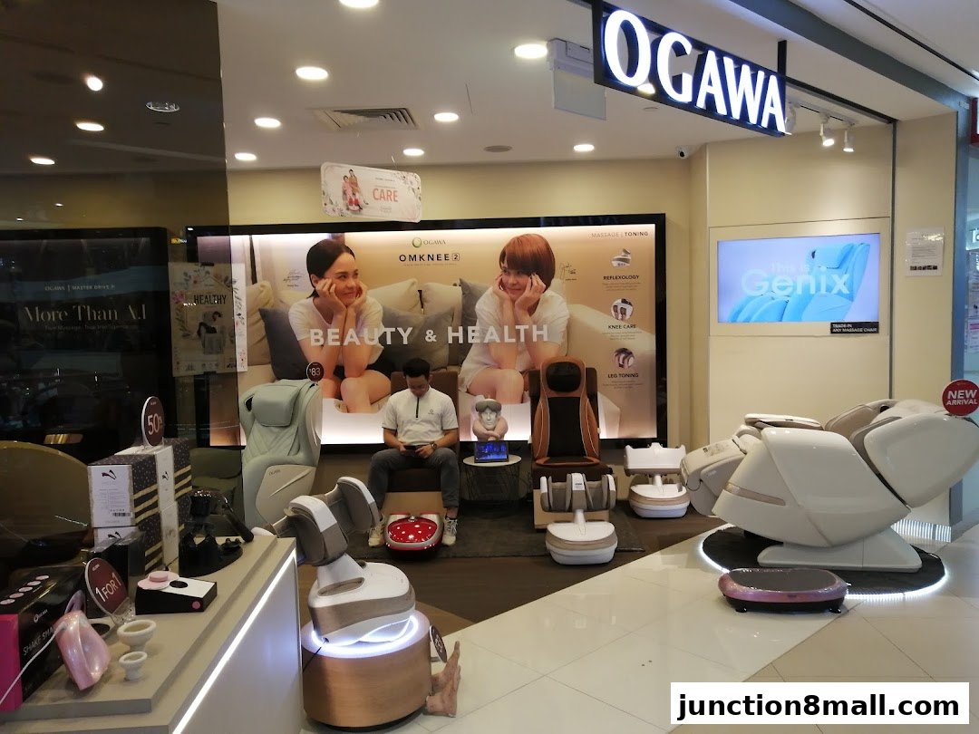 OGAWA shop interior showcasing various massage chairs and foot massagers with promotional displays.
