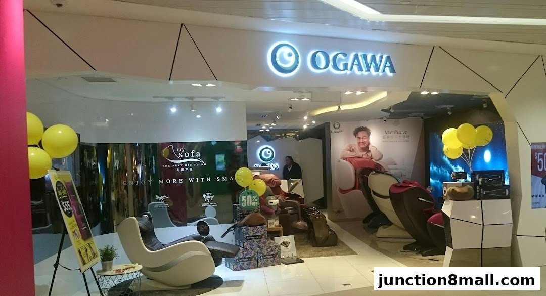 OGAWA store interior showcasing massage chairs and promotional displays with yellow balloons.