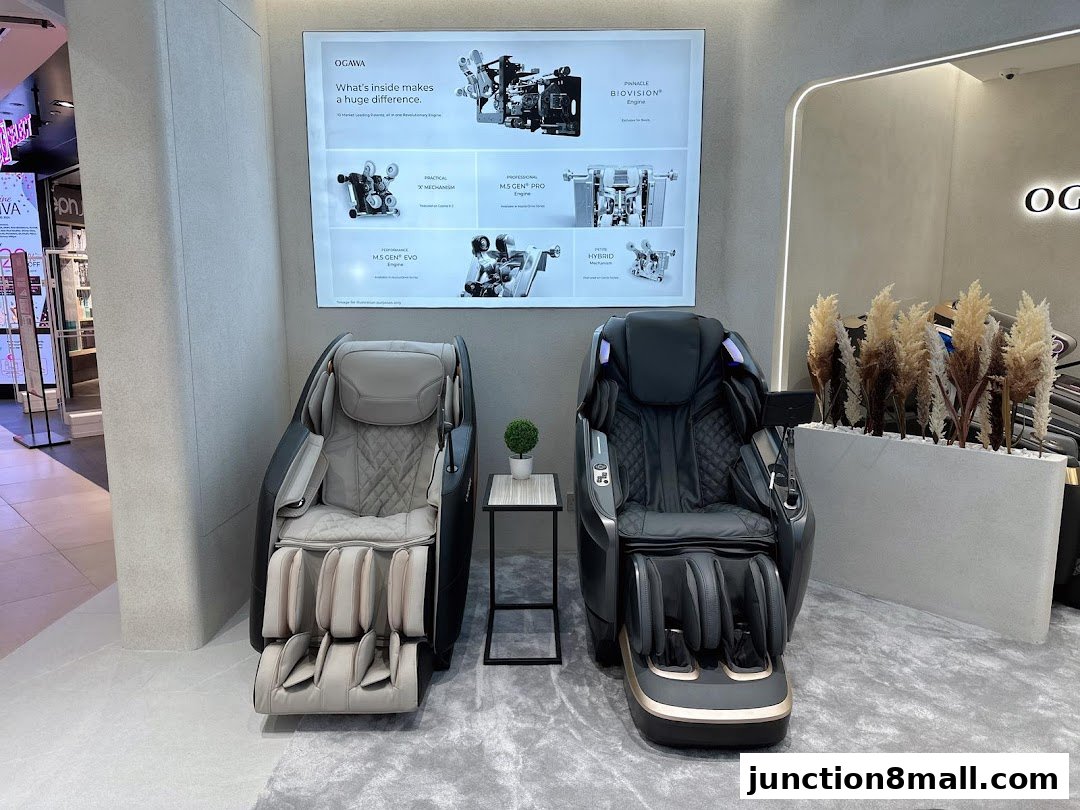 Two OGAWA massage chairs are displayed with a poster detailing their internal mechanisms.