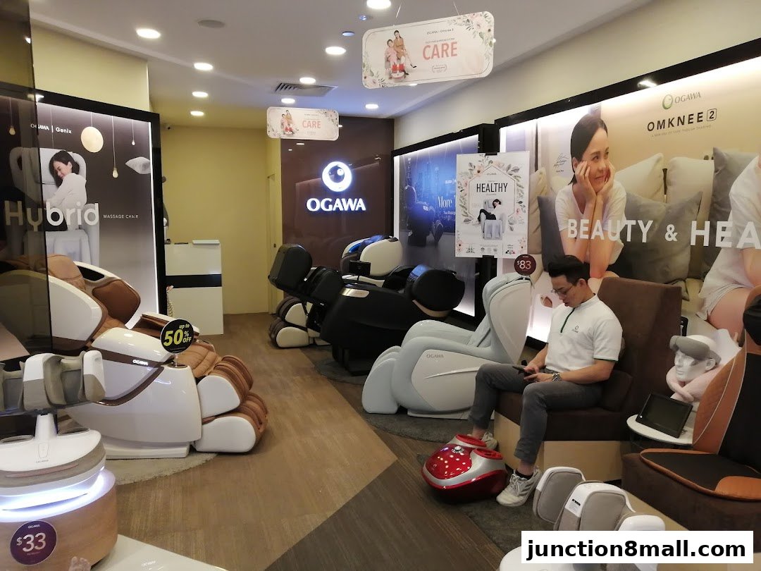 Interior view of an OGAWA massage chair store showcasing various massage chairs and promotional displays.