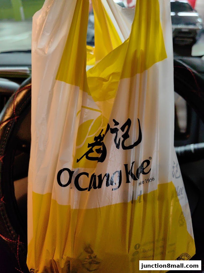 A white and yellow plastic bag with the Old Chang Kee logo and text.