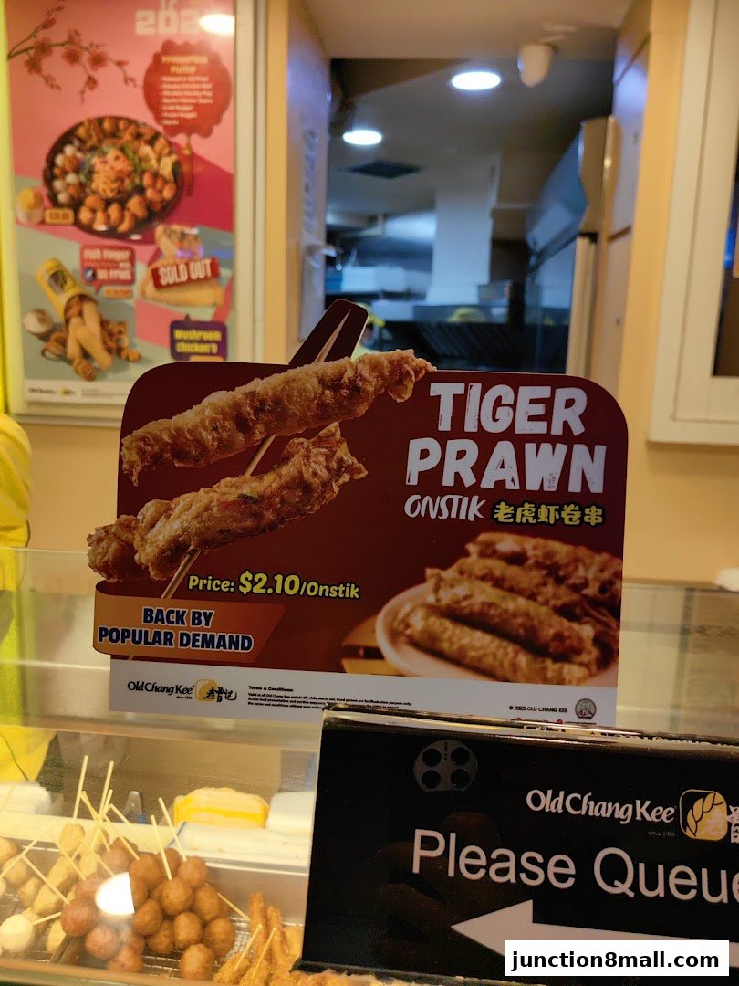 A sign advertises Old Chang Kee's Tiger Prawn Onstik, priced at $2.10.