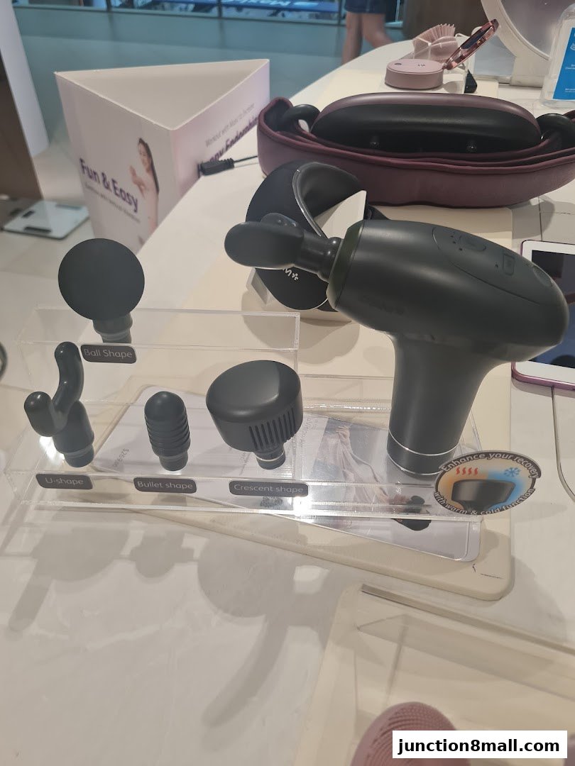 A display of massage gun attachments and a massage device.