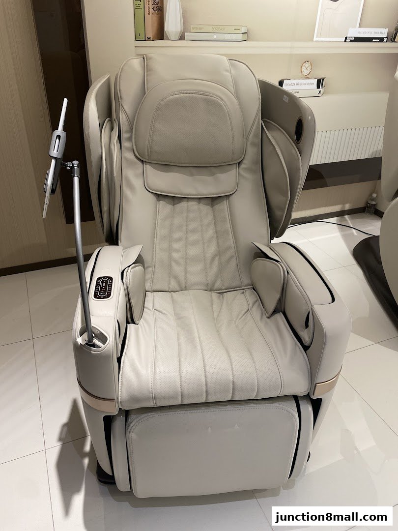 A luxurious, cream-colored massage chair with a built-in tablet holder and control panel.