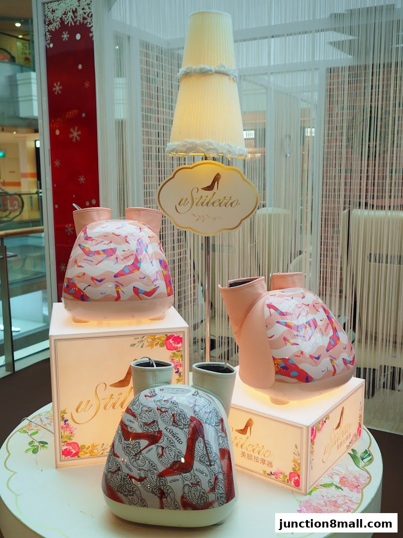 OSIM Stiletto foot massagers displayed with decorative elements and lighting.
