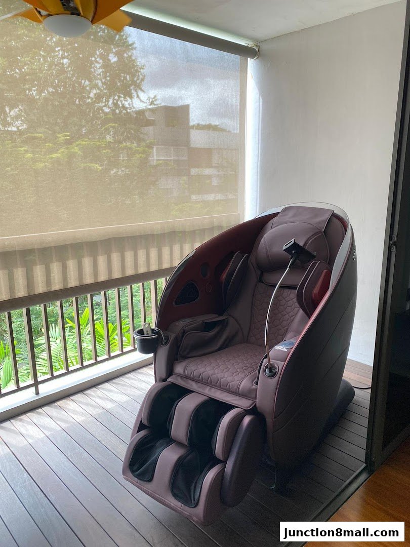 A luxurious massage chair is placed on a wooden deck with a view of greenery.