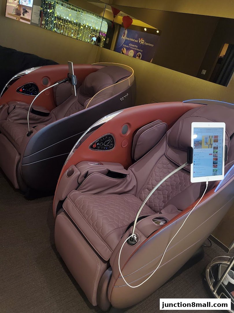 Two luxurious massage chairs with attached tablets, offering a relaxing experience.