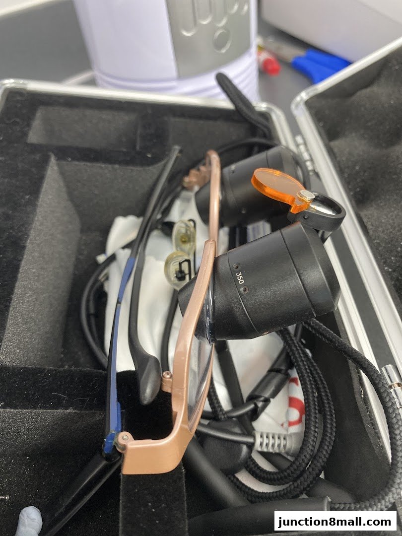 A close-up view of an optometry tool kit with glasses and lenses inside a case.