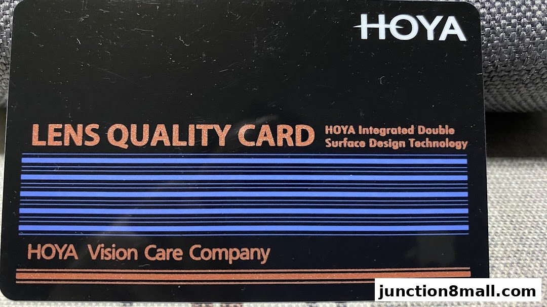 A black card with 'HOYA Lens Quality Card' and 'HOYA Vision Care Company' text.