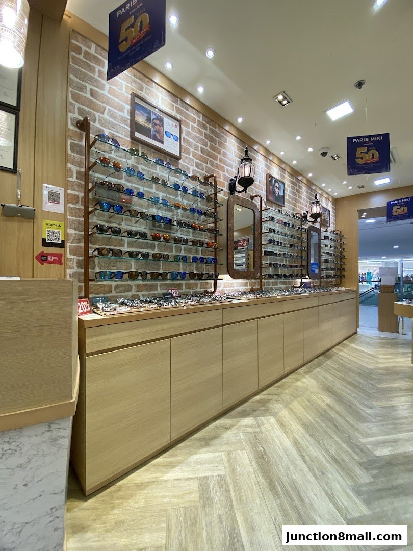 Interior view of an optician shop with shelves displaying various eyeglasses and sunglasses.