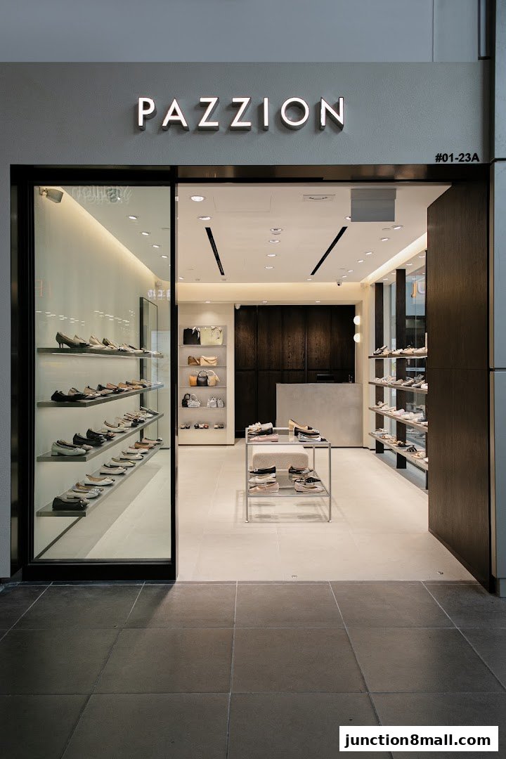 The exterior of a modern shoe store, PAZZION, showcasing stylish footwear on shelves.