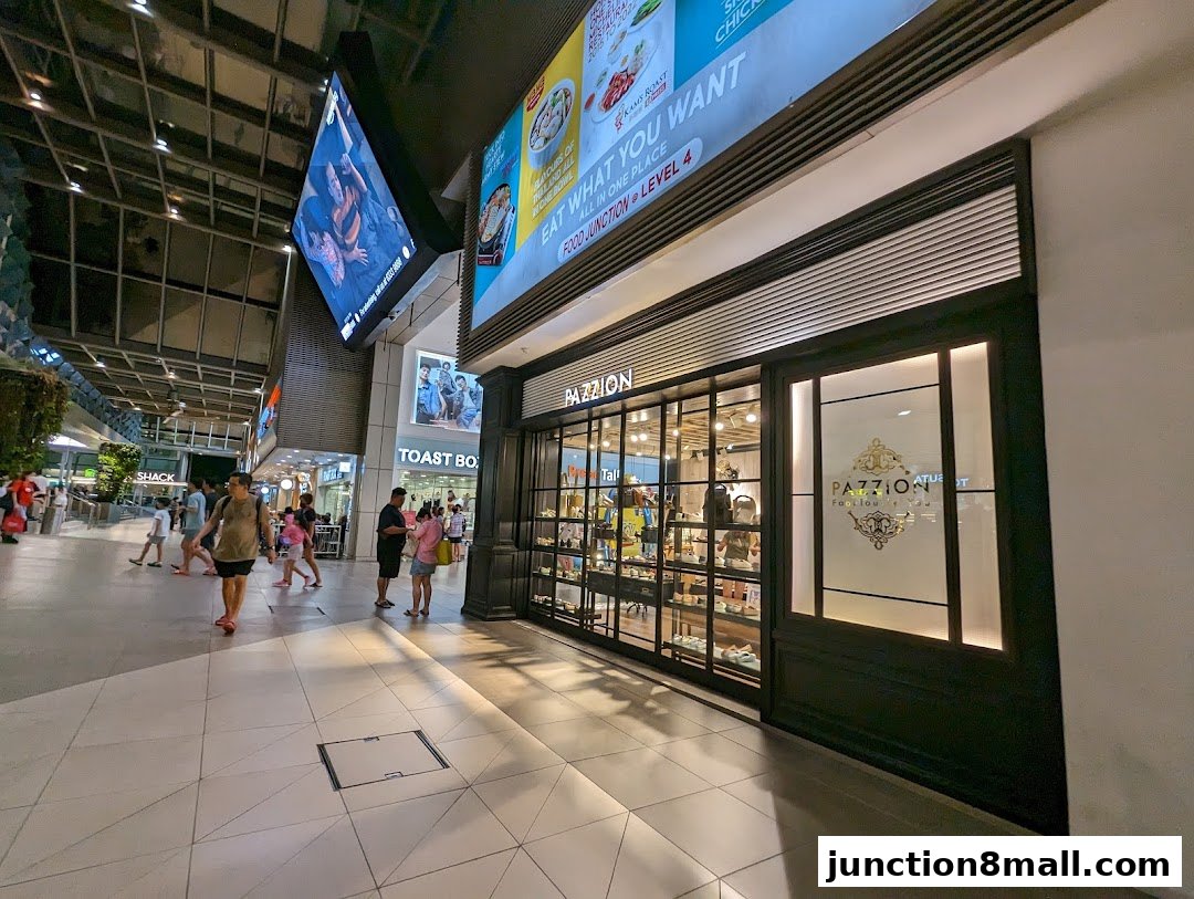 The PAZZION shoe store entrance with display windows and a frosted glass door.