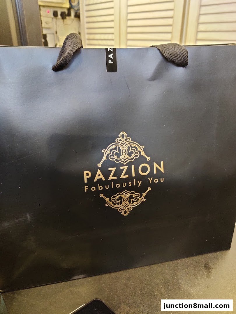 A black shopping bag with the PAZZION logo and slogan 'Fabulously You'.