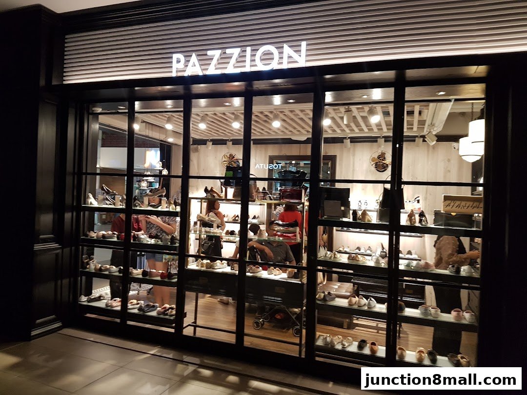 The PAZZION Junction 8 shoe store features a well-lit display window showcasing various footwear styles.