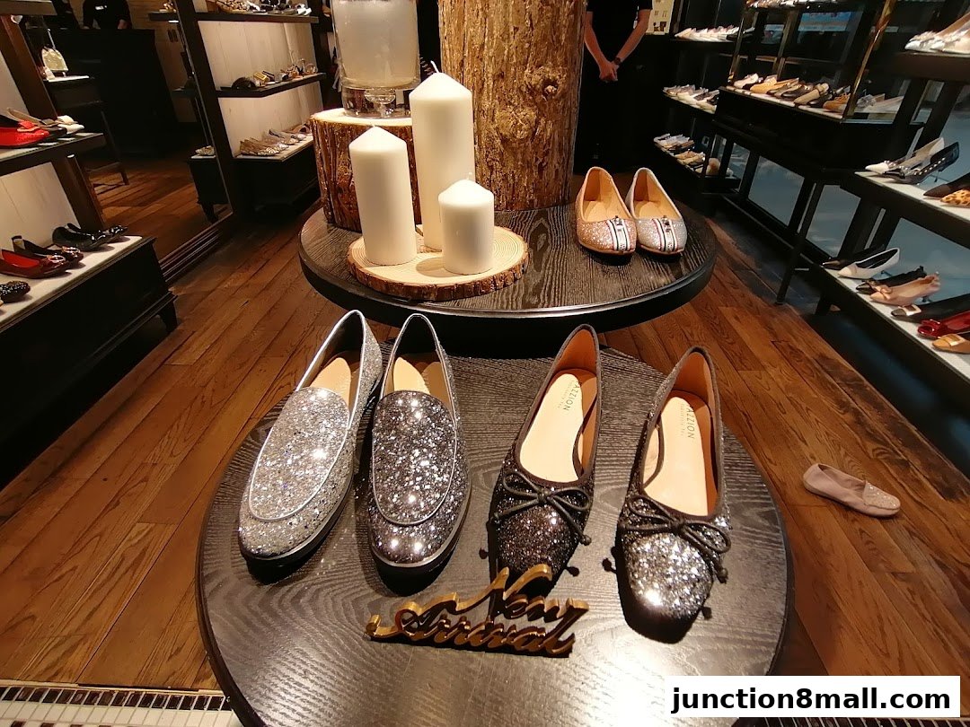 A display of sparkly flat shoes and loafers in a shoe store.