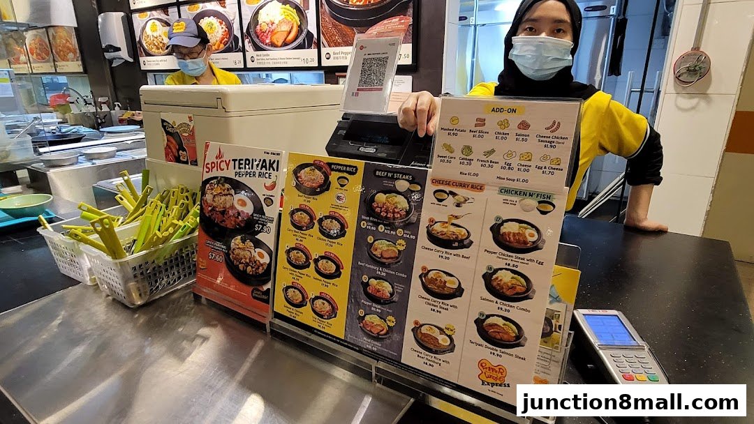 A Pepper Lunch Express counter with menus and staff serving food.