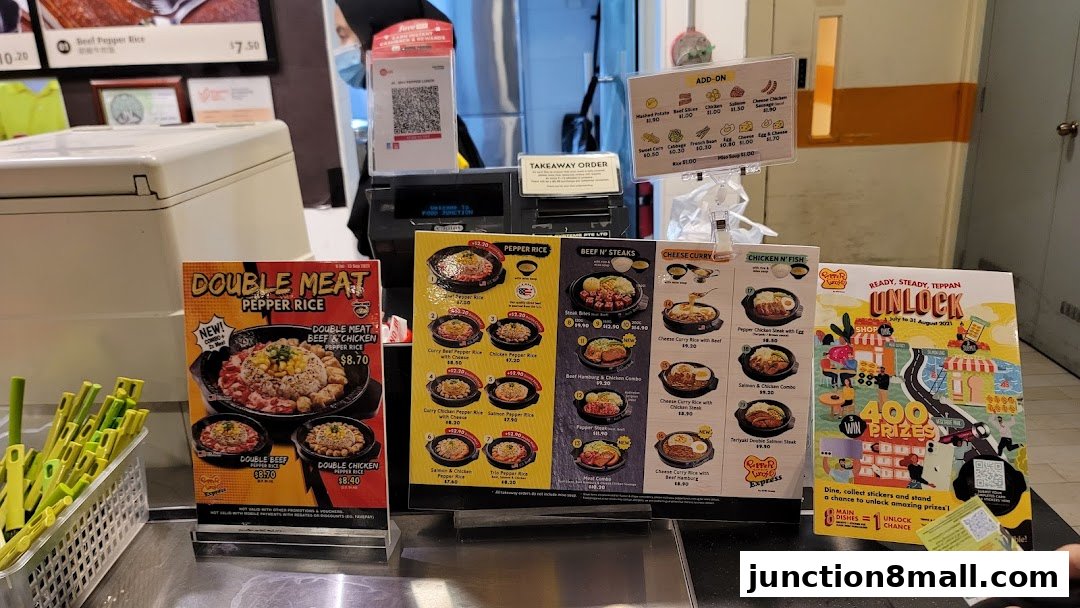 A display of Pepper Lunch Express menu items and a promotional poster.
