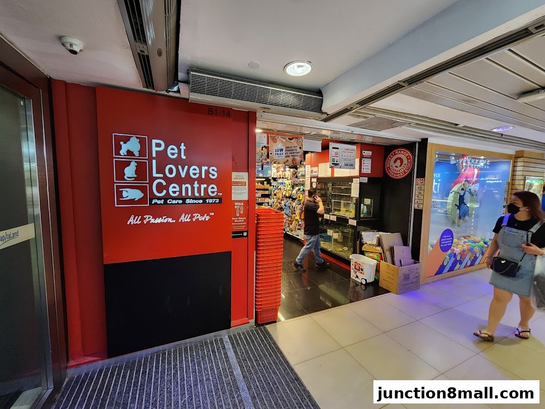 The entrance to Pet Lovers Centre, a pet store with a red facade and various pet supplies visible inside.