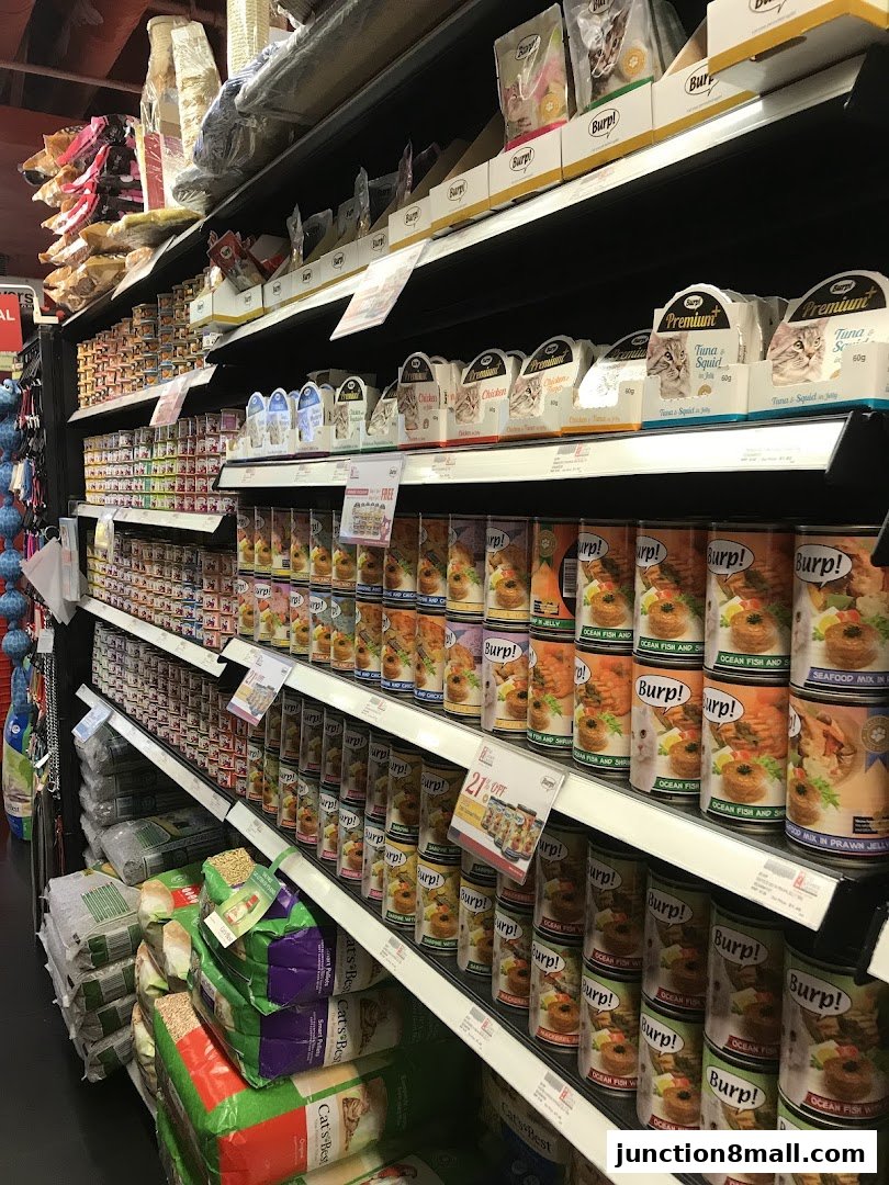Shelves stocked with various pet food products, including canned food and bags of litter.