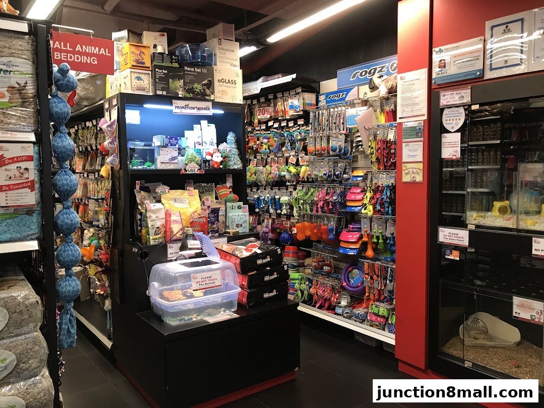 Interior view of a pet supply store with shelves stocked with pet food, toys, bedding, and accessories.