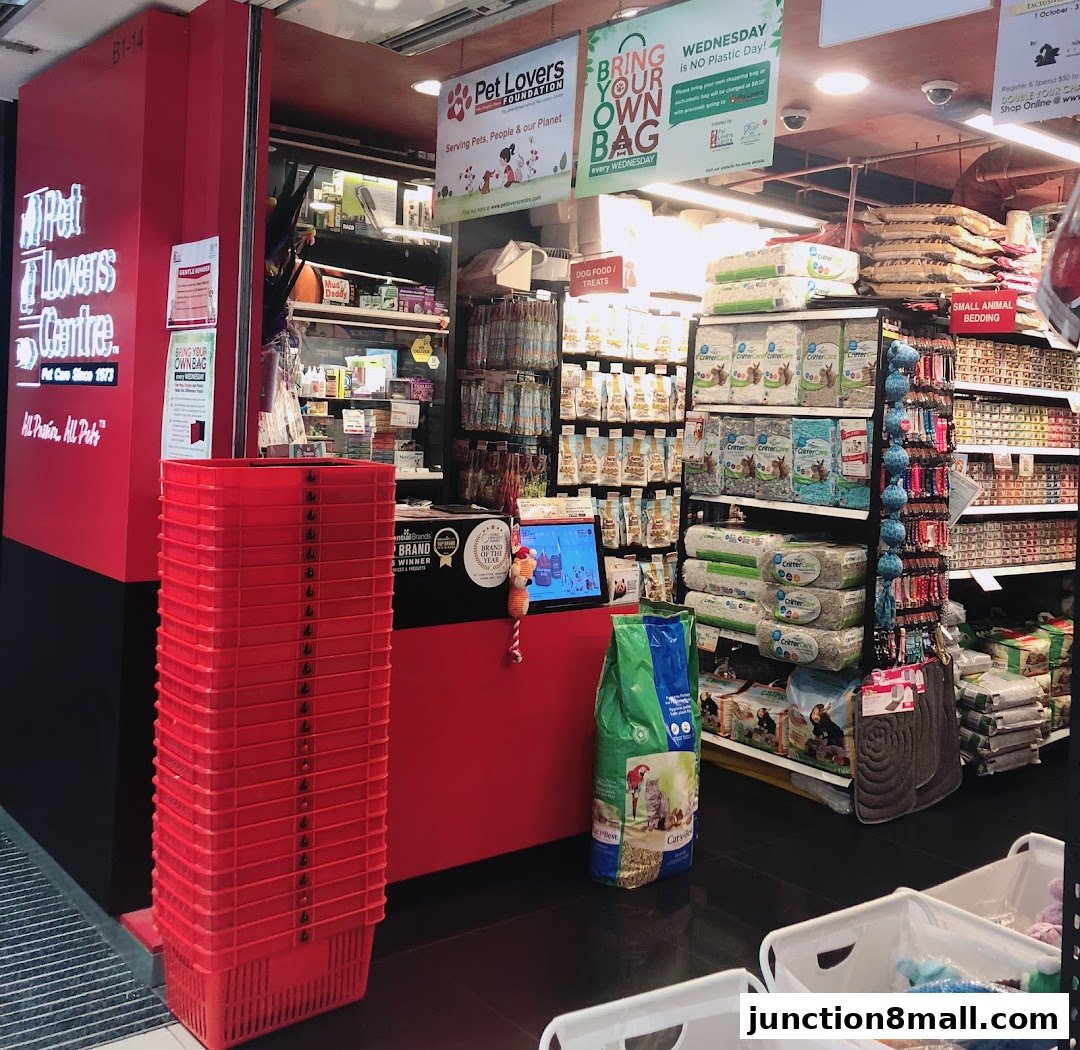 The entrance of Pet Lovers Centre, showcasing pet food, bedding, and shopping baskets.
