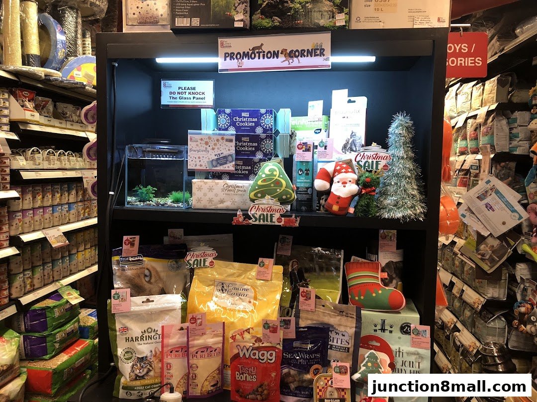 A display shelf in a pet store featuring Christmas-themed pet products and food.