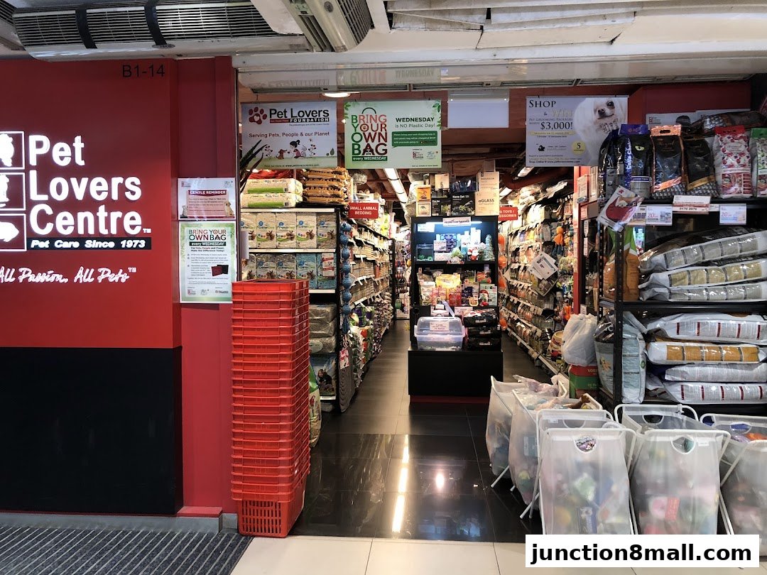 The entrance to Pet Lovers Centre, a pet supply store, with shelves stocked with pet food and accessories.