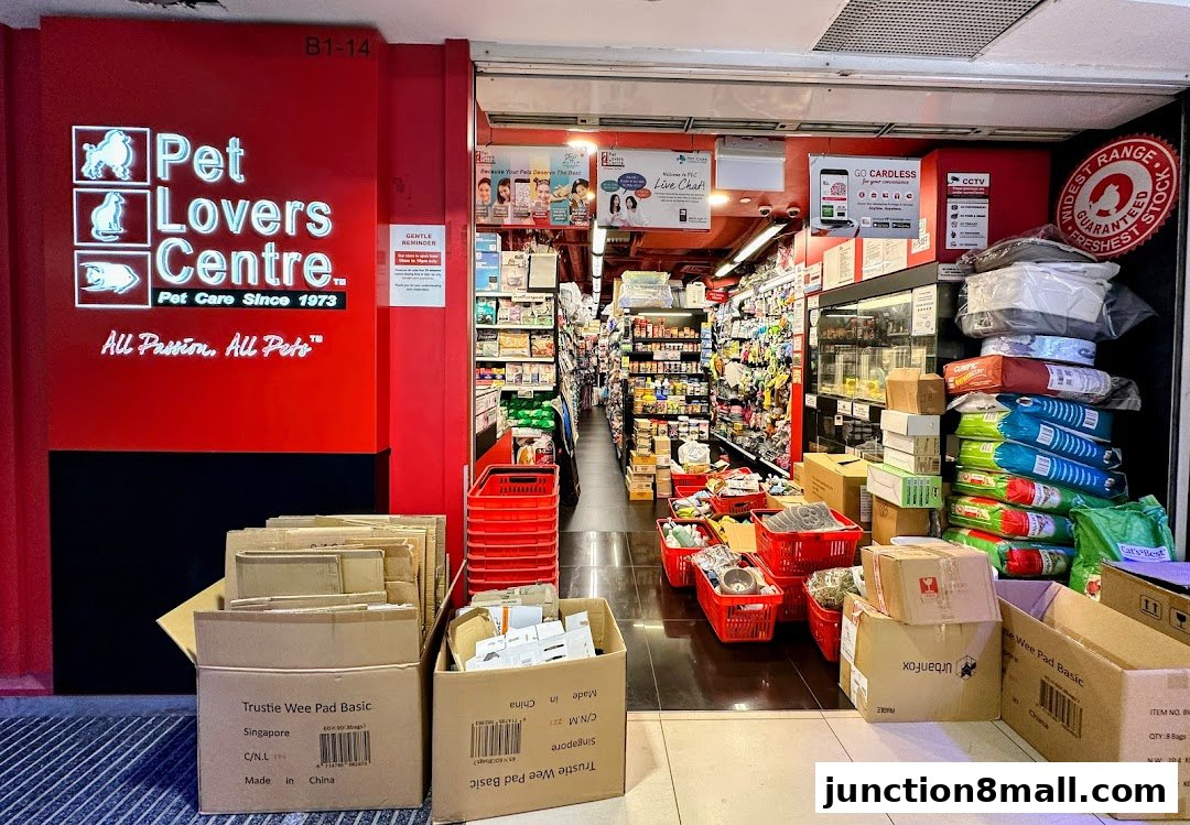 The entrance of Pet Lovers Centre, a pet supply store, with products displayed inside and outside.