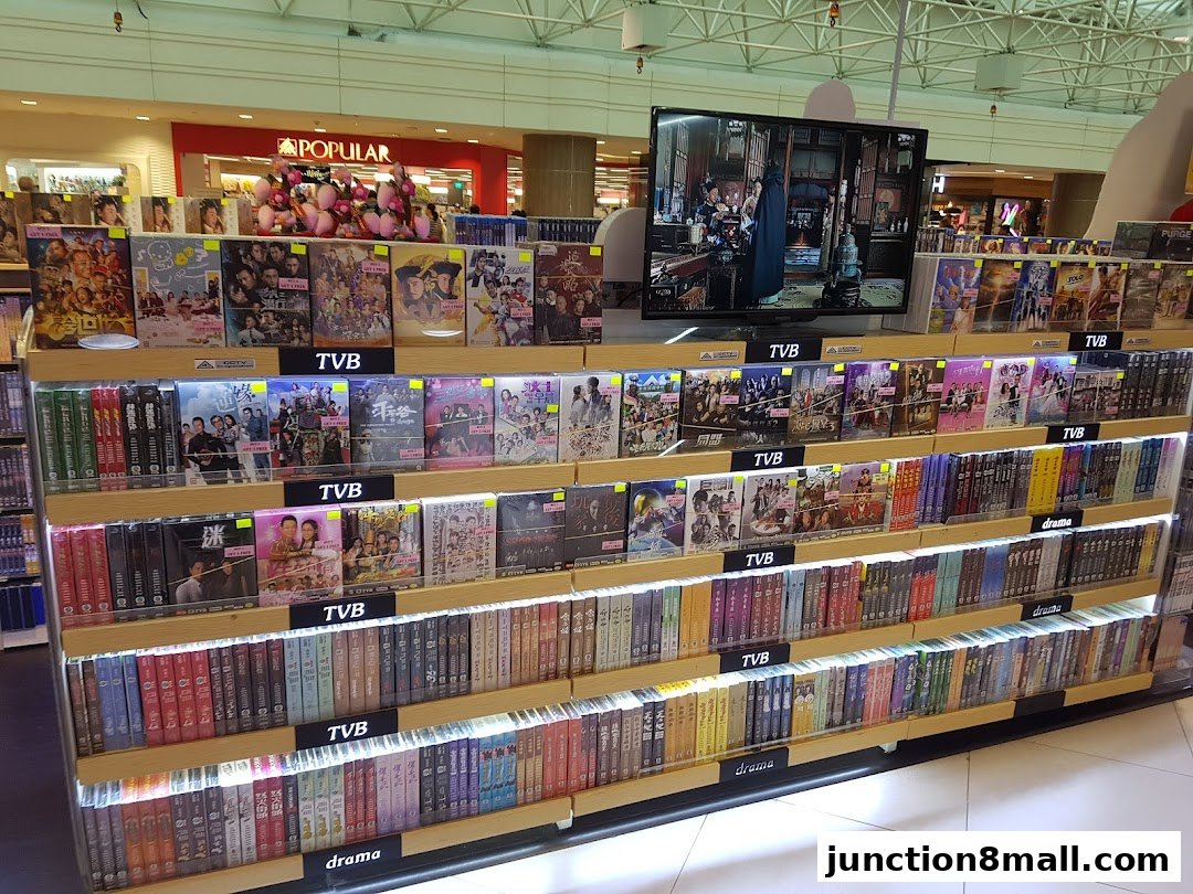 A display of TVB dramas and other movies on shelves, with a TV screen showing a scene.