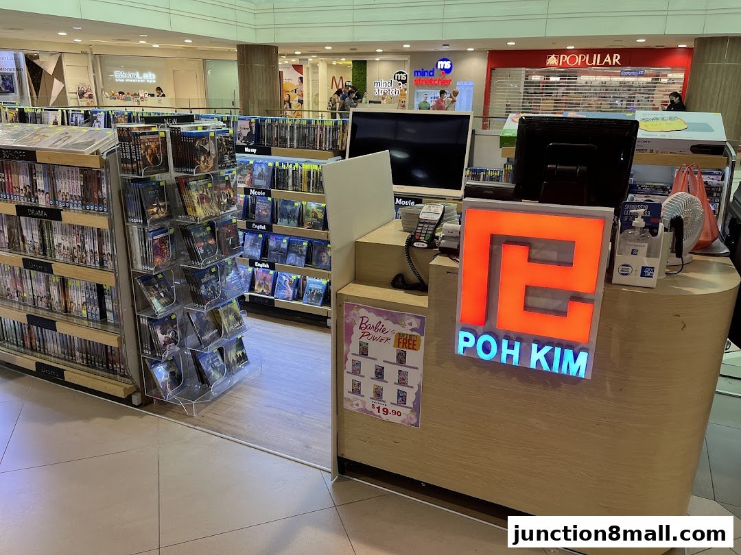 A retail shop called Poh Kim Video displaying shelves of movies and a counter with the store's logo.