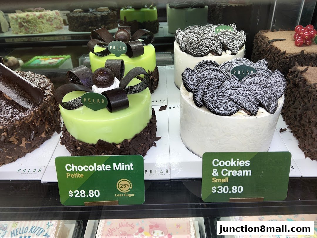 A display of various cakes, including chocolate mint and cookies and cream flavors.