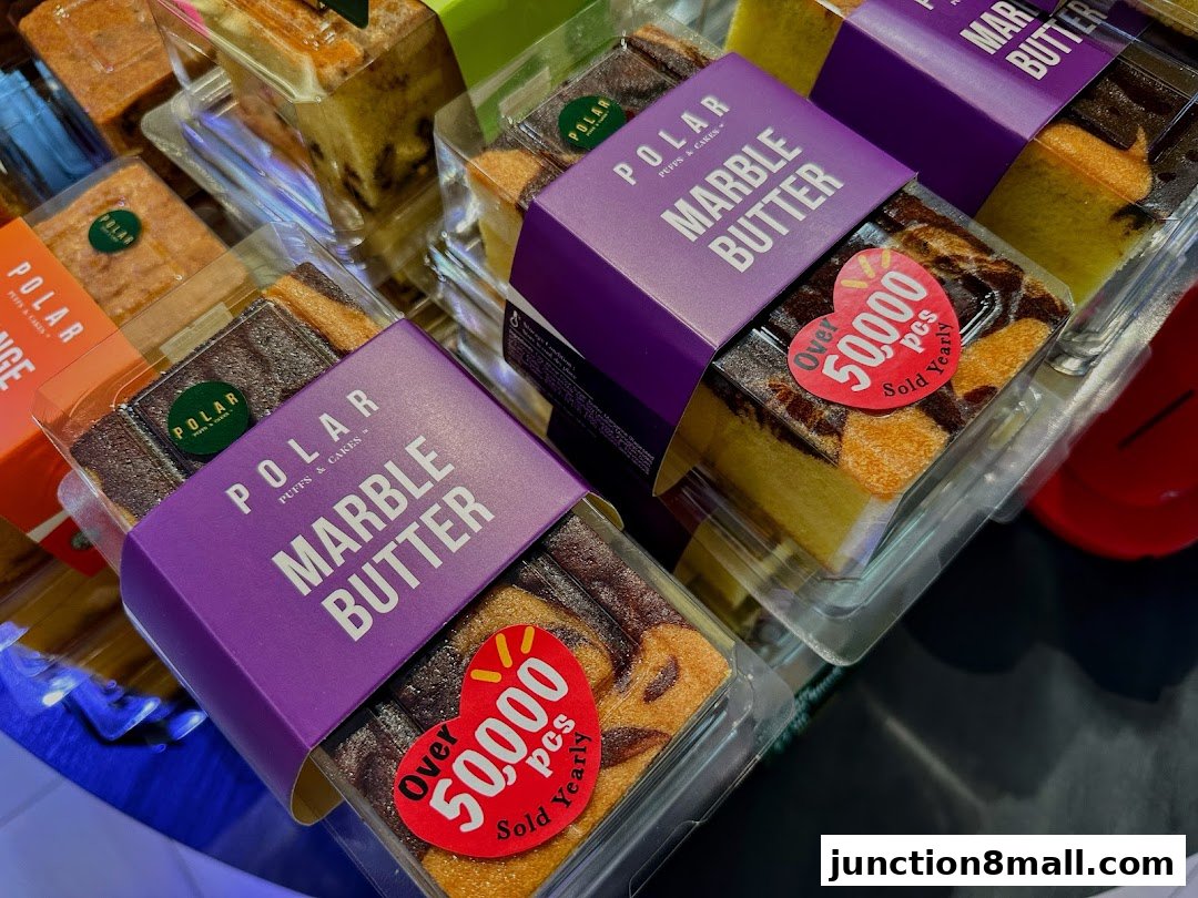 Close-up of packaged marble butter cakes with branding and sales stickers.