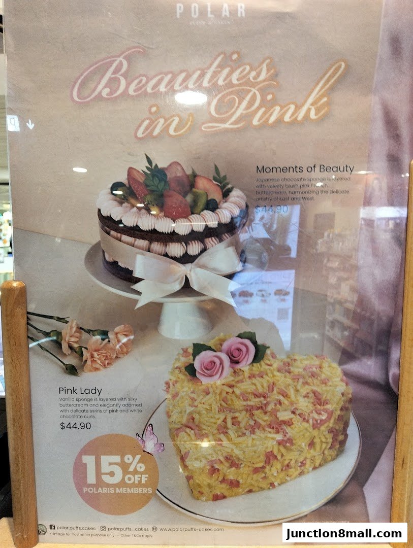 A display featuring two cakes, one round and one heart-shaped, with descriptions and prices.