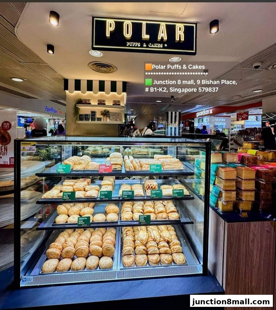 A display case filled with various pastries and cakes at Polar Puffs & Cakes.