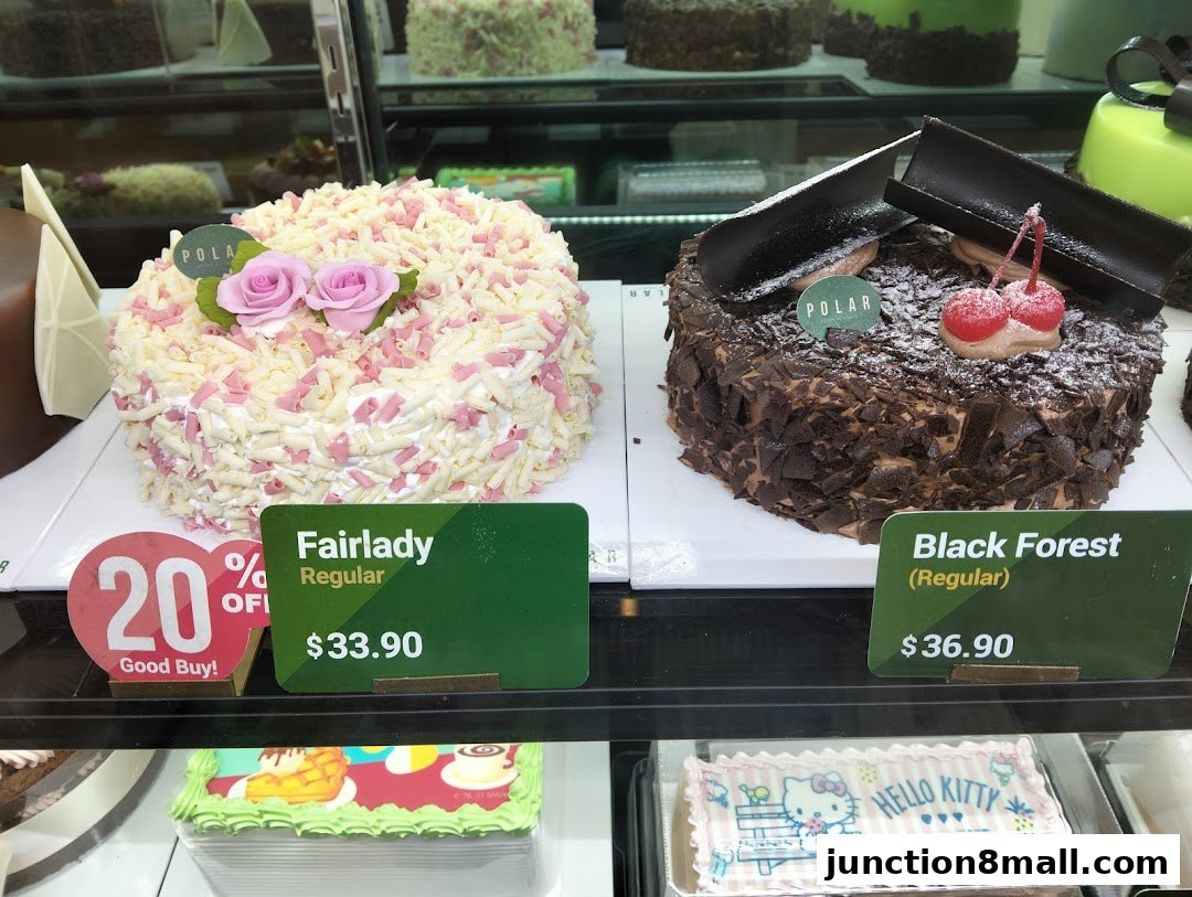 A display of delicious cakes, including Fairlady and Black Forest flavors, with prices and a 20% off offer.
