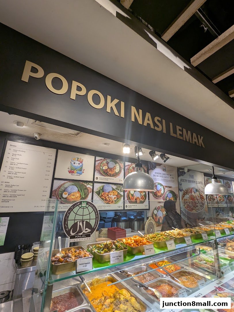 Popoki Nasi Lemak shop front with a display of food and a menu board.