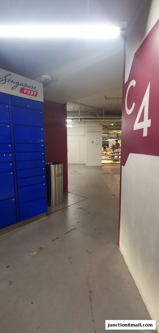 A hallway with Singapore Post lockers and a large 'C4' sign on the wall.
