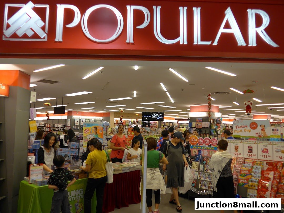 Interior view of a POPULAR bookstore with customers browsing shelves and displays.