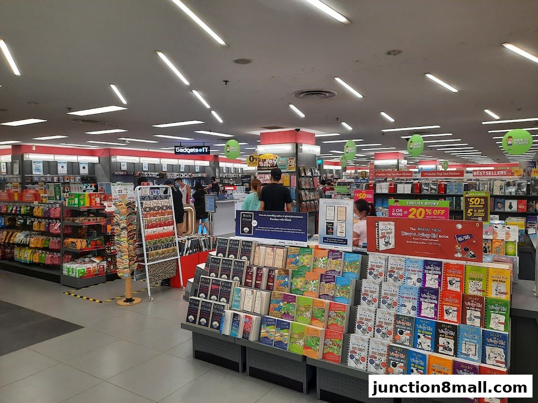 Interior view of a Popular Bookstore with shelves of books, stationery, and promotional displays.