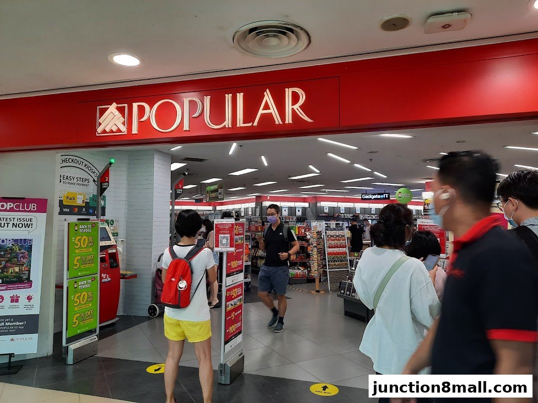 The entrance to a POPULAR bookstore with promotional displays and customers.